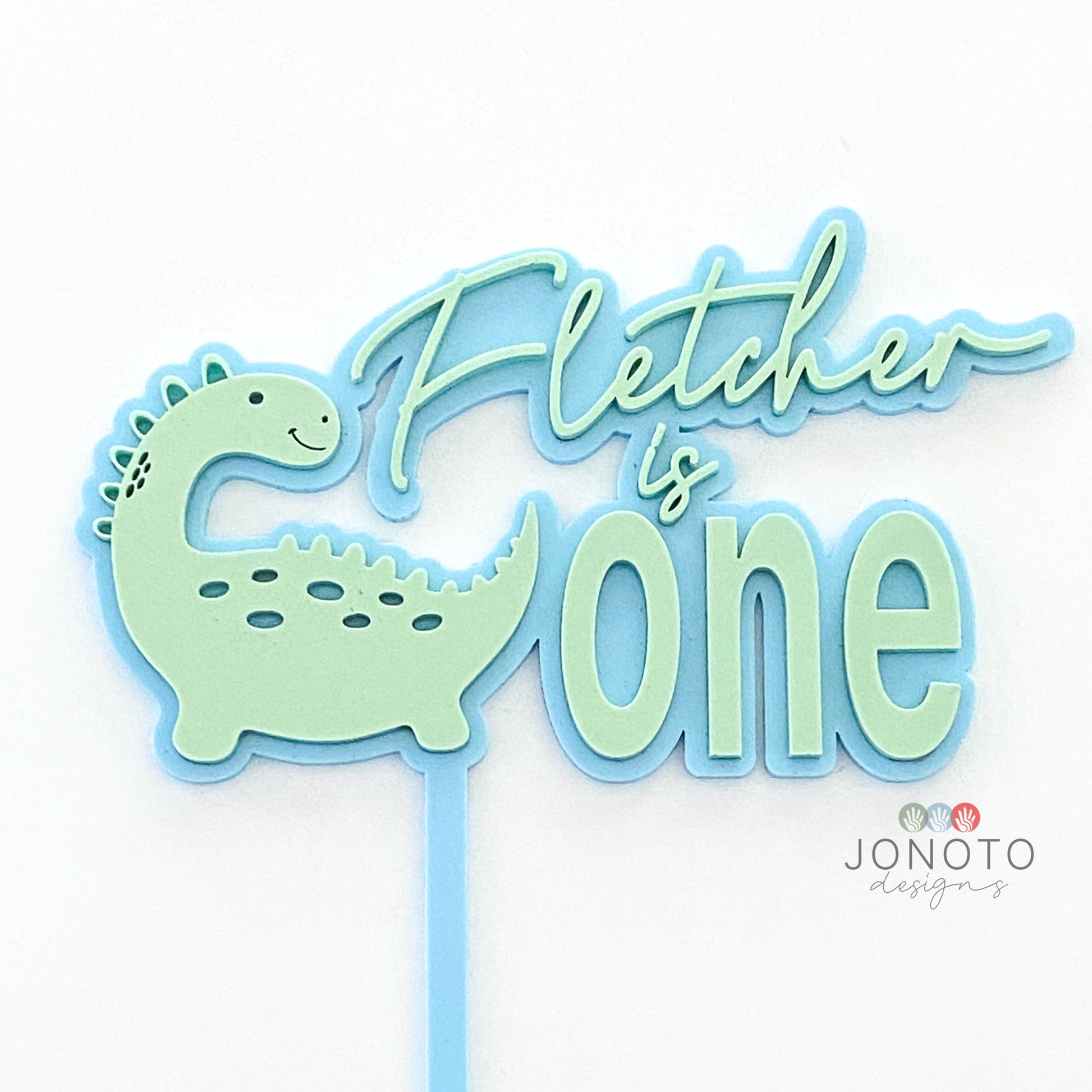 Dinosaur themed birthday cake topper