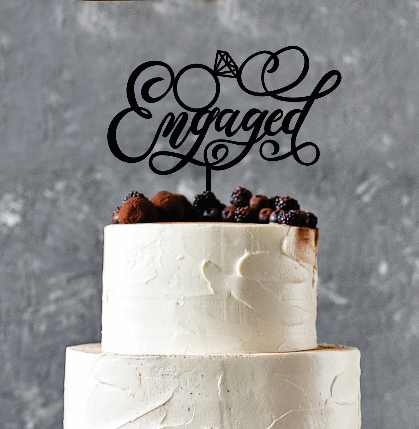 cake displaying engaged cake topper