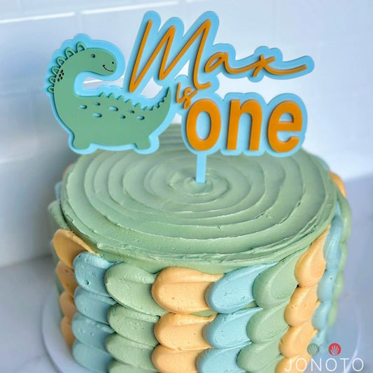 Birthday cake topper with green dinosaur