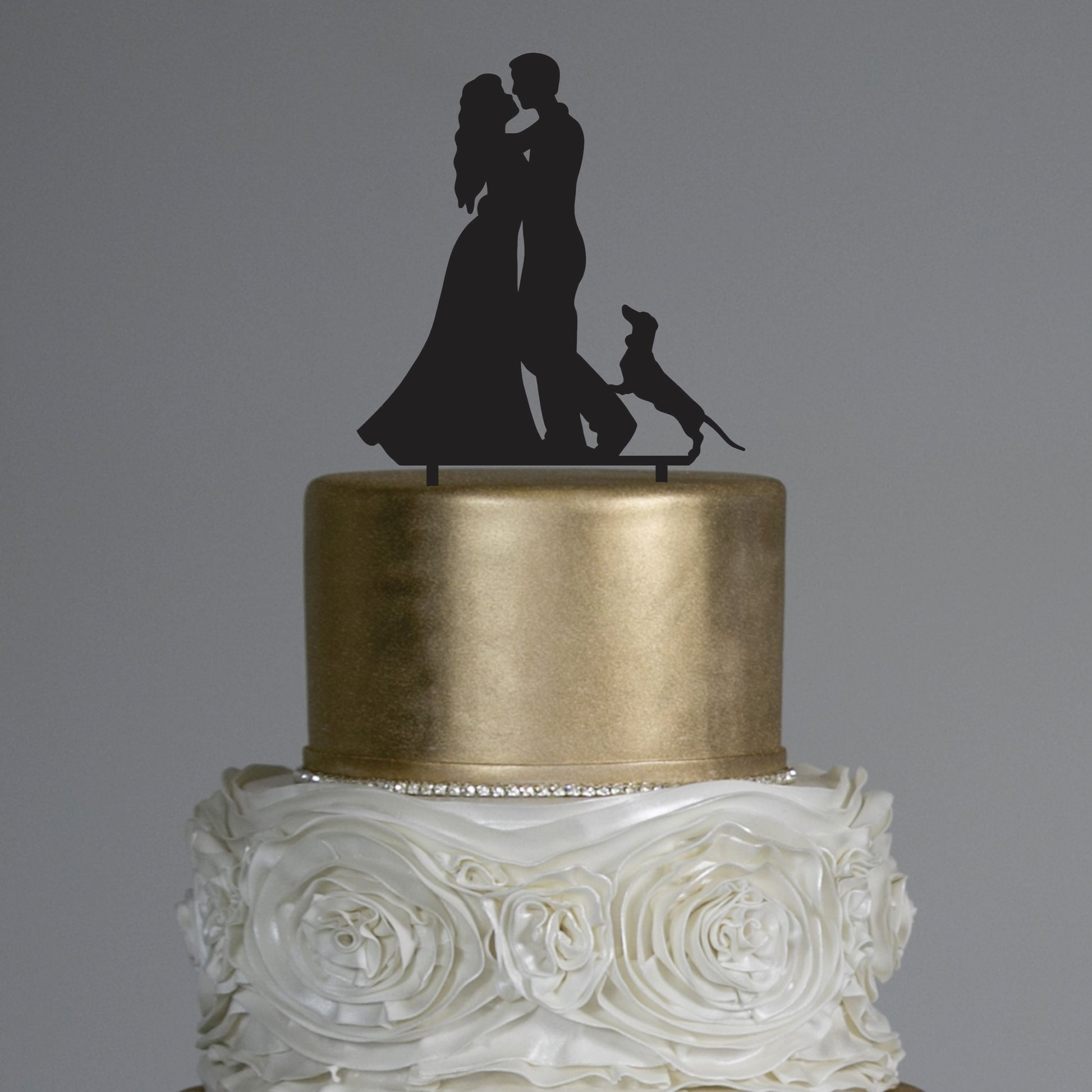 Silhouette cake topper featuring bridal couple and sausage dog
